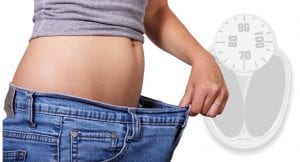Woman measuring her weight loss after experiencing weight gain following a car accident