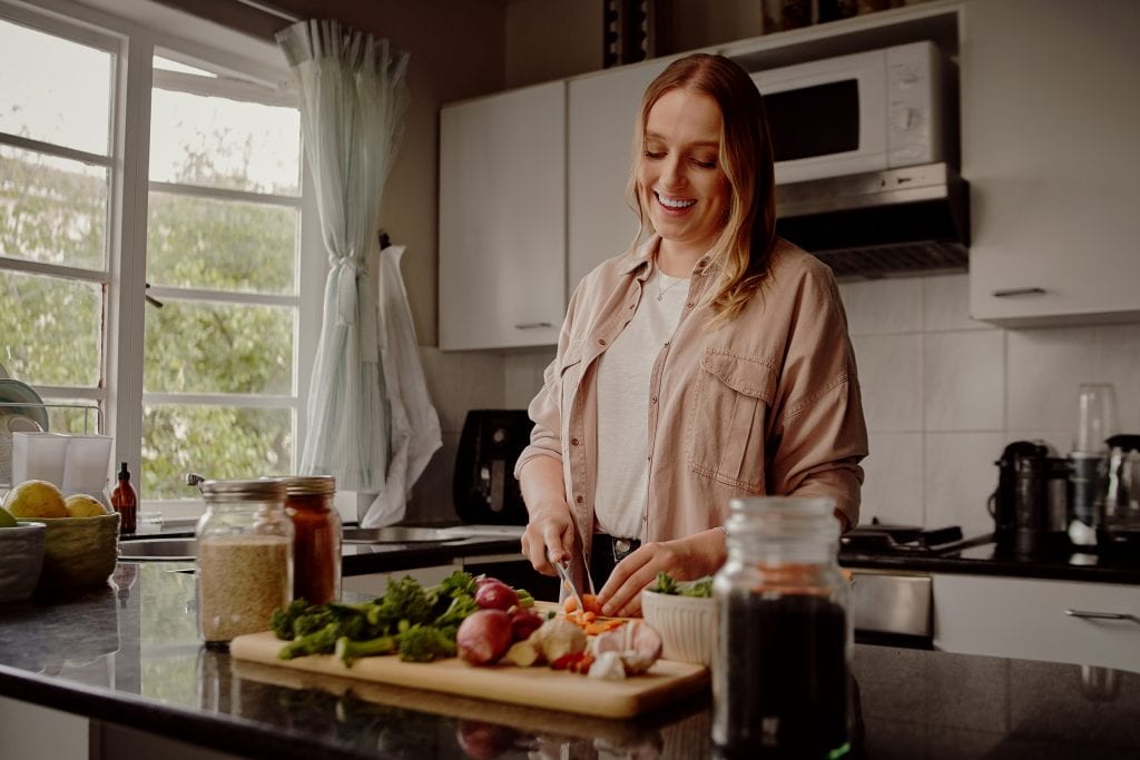 Woman enjoying weight loss from eating fresh fruit and vegetables after being injured in an accident