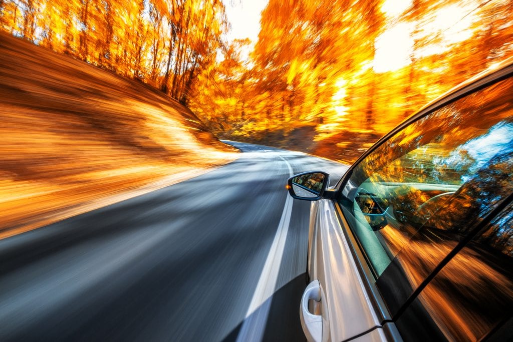 Car speeds on West Virginia rural road.